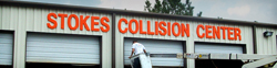 Car repair business sign mounted above garage