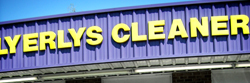 Letters mounted above a dry cleaner's storefront