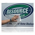 Picture of vinyl lettering and graphics being applied to surface